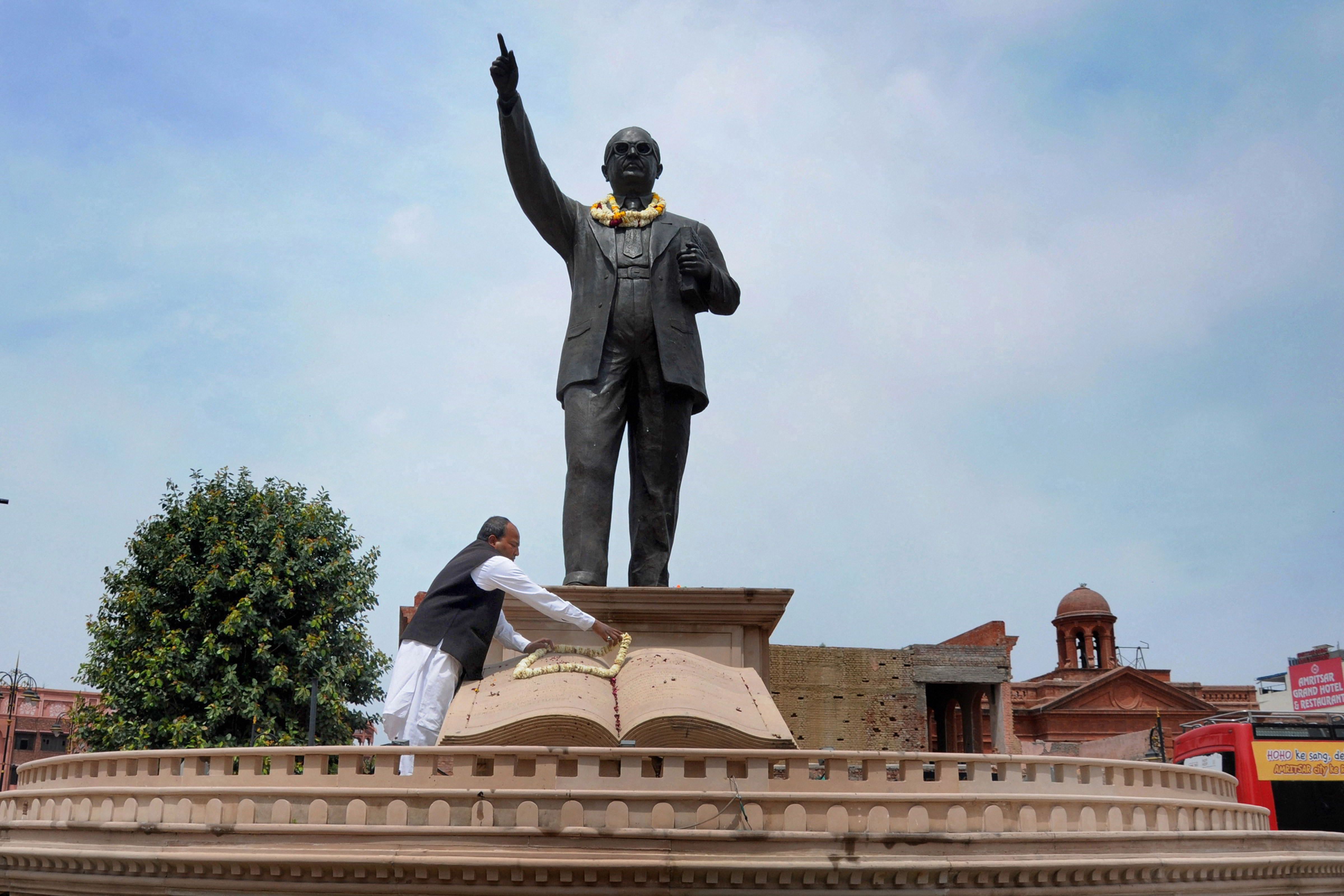 A man pays tribute to Babasaheb Dr BR Ambedkar on his birth anniversary, amid the nationwide coronavirus lockdown, in Amritsar, Tuesday, April 14, 2020.