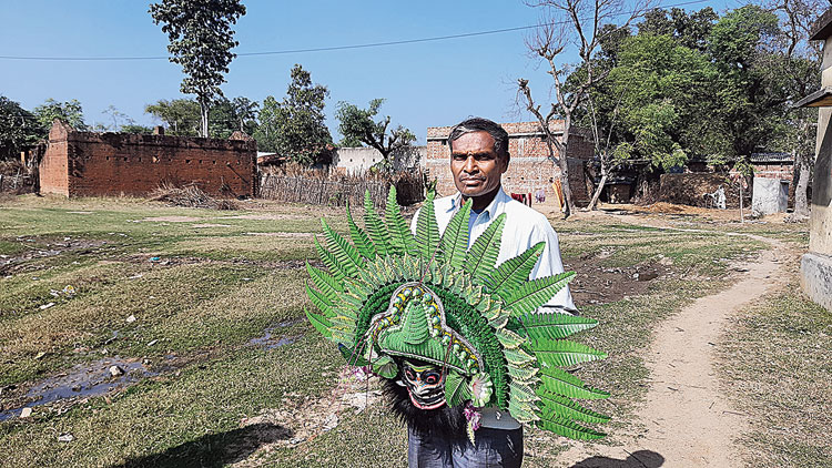 Kartik Singh Mura with the mask of a demon. 
