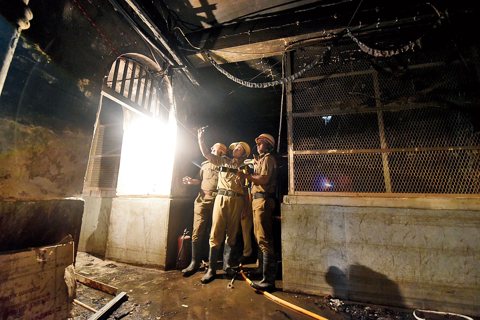 A fire services team inspects the gutted storeroom of the pharmacy at Calcutta Medical College and Hospital on Thursday. 