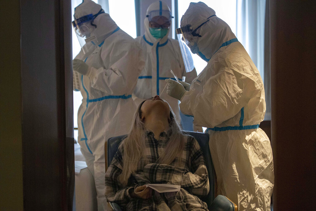 A woman takes a Covid-19 test at a quarantine hotel in Wuhan in central China's Hubei province.