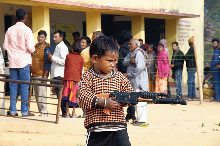 Priyanshu Munda poses with a toy gun at a polling booth at Sutiyambe village under Kanke Assembly constituency in Ranchi on Thursday. 