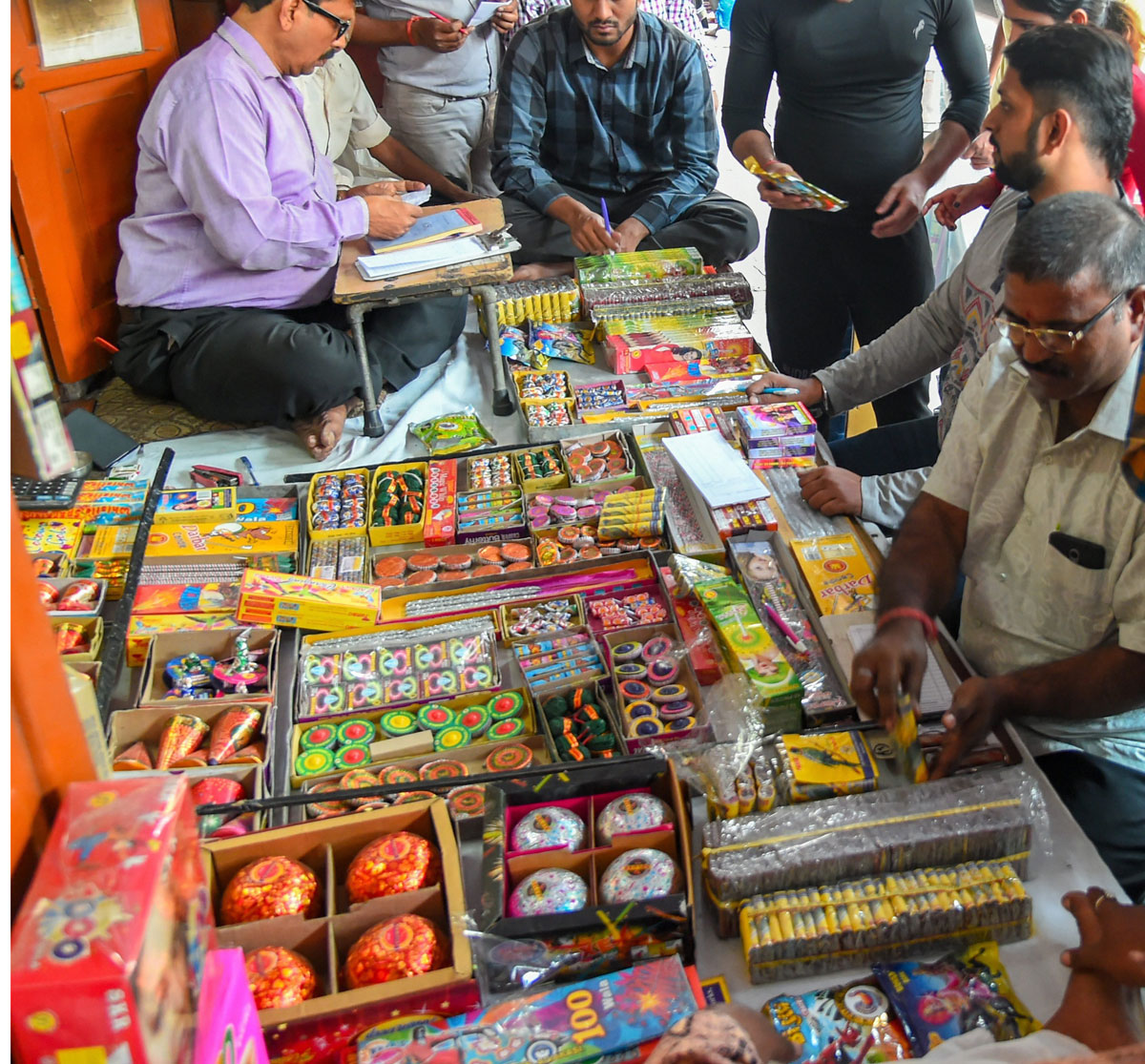 People purchase firecrackers in a market ahead of the festival of Diwali in New Delhi on Tuesday. 