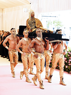 Billy Porter: Always one to turn heads with his sartorial choices, Billy Porter scripted Met Gala history in 2019 when he was carried in by six men on a chaise-like contraption but only more ornate. What more? He was dressed in a custom bejewelled catsuit with 10-feet wings by The Blonds, a 24-carat gold headpiece, custom gold-leaf Giuseppe Zanotti shoes and fine jewels, to finish his look of the sun god.