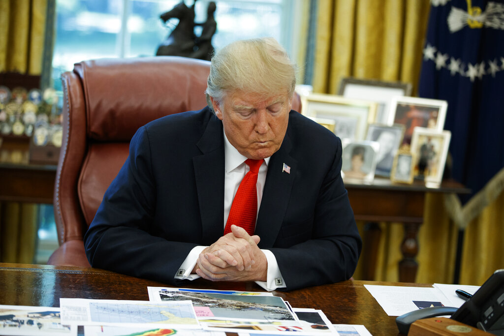 President Donald Trump looks at his notes during a briefing on Hurricane Dorian in the Oval Office of the White House, on September 4, 2019, in Washington