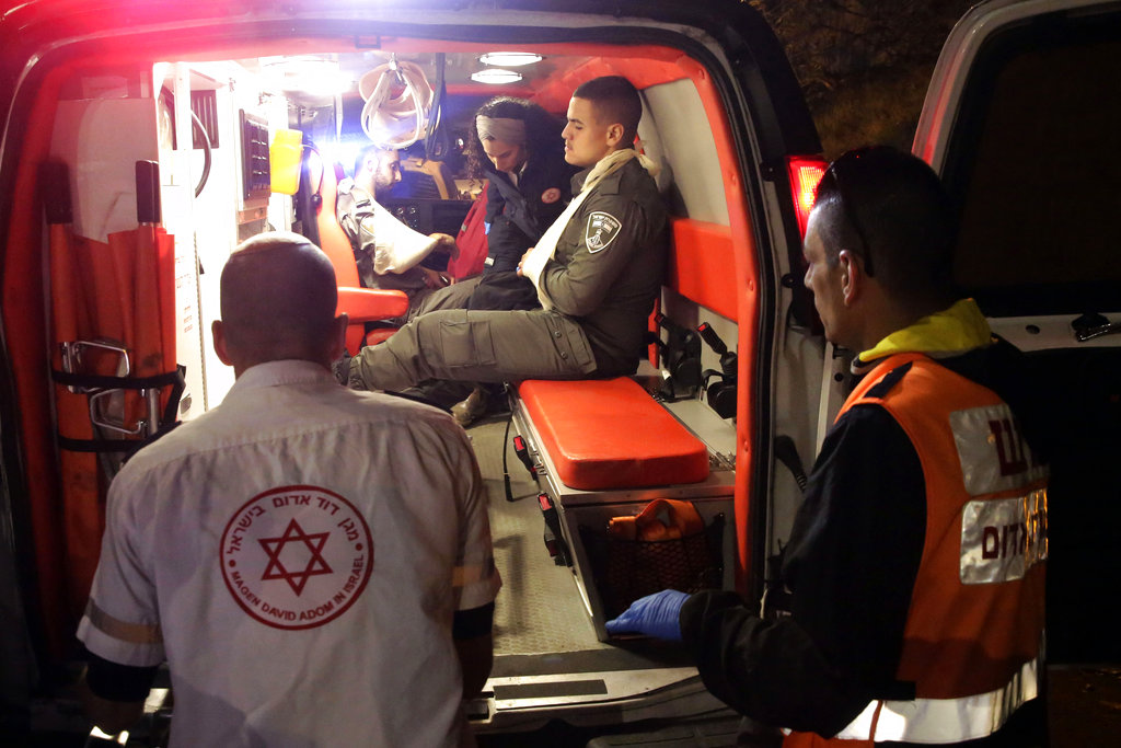 An Israeli border police officer sits in an ambulance in Jerusalem early on Thursday.