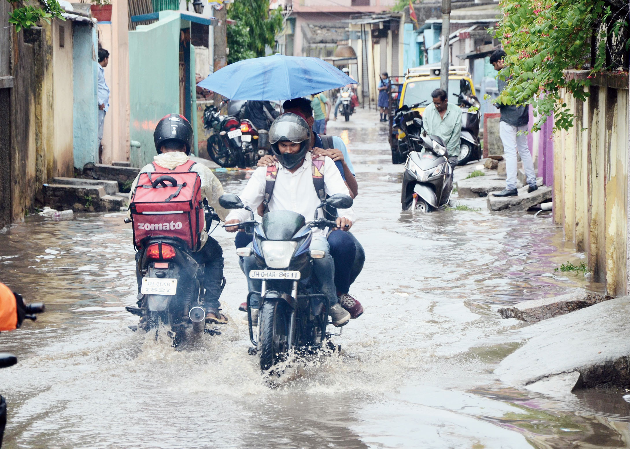 Commuters negotiate the waterlogged Ratu Road in Ranchi on Wednesday. 
