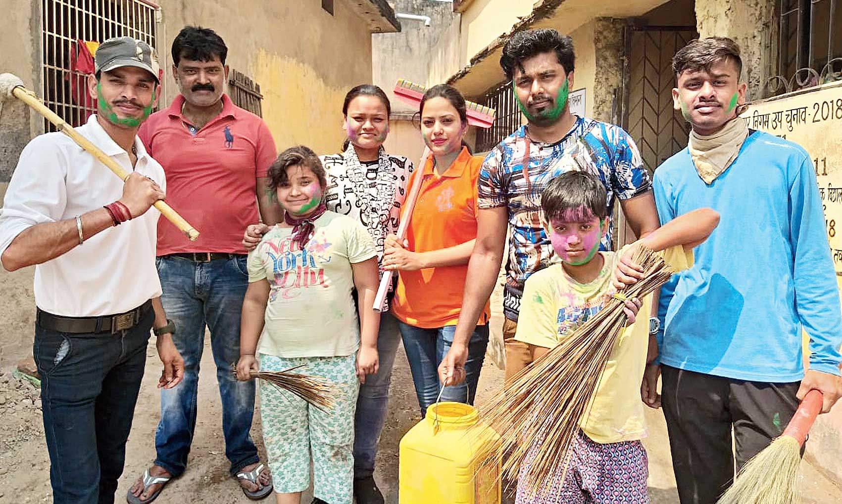 Volunteers of NGO Samadhan with gulal smeared on their faces after conducting a cleaning drive at Gandhi Muhalla in Dhanbad on Thursday. 
