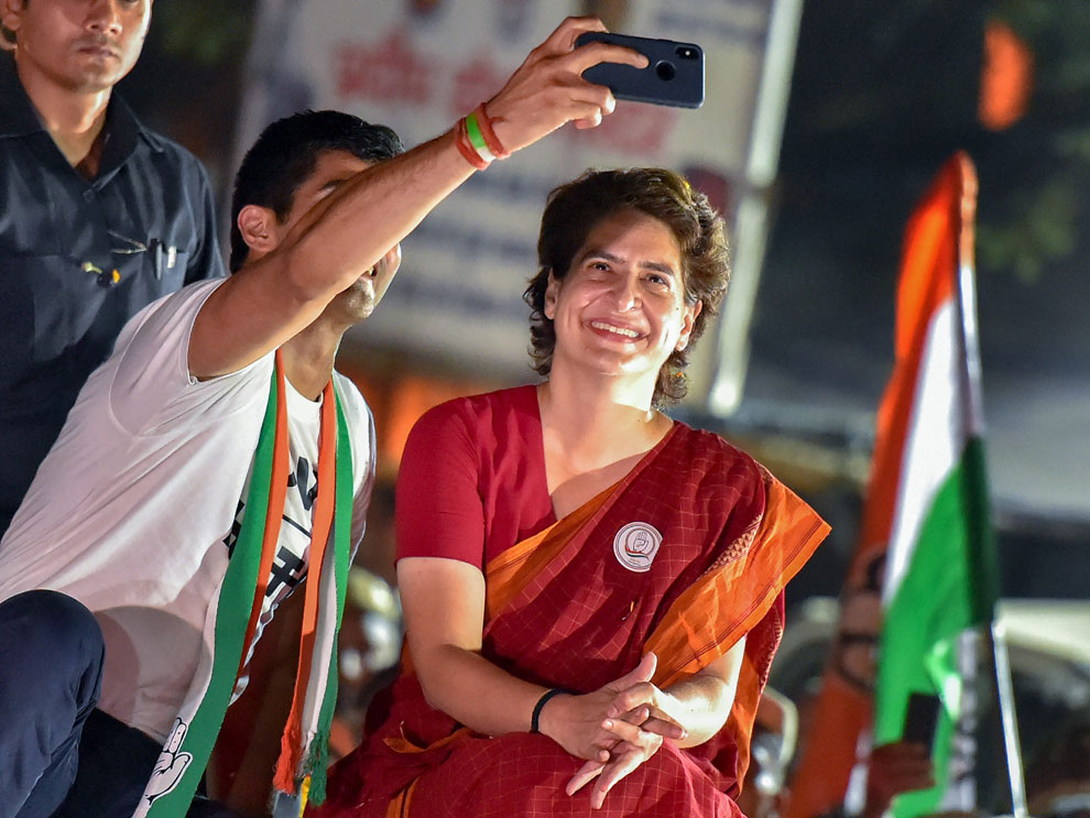 Congress leader Priyanka Gandhi Vadra poses for a selfie with party's South Delhi candidate boxer Vijender Singh at the end of an election campaign roadshow for the Lok Sabha polls, in New Delhi, Wednesday, May 8, 2019.