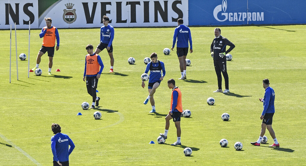 Players of Bundesliga football club Schalke 04 exercise in Gelsenkirchen, Germany on Thursday.