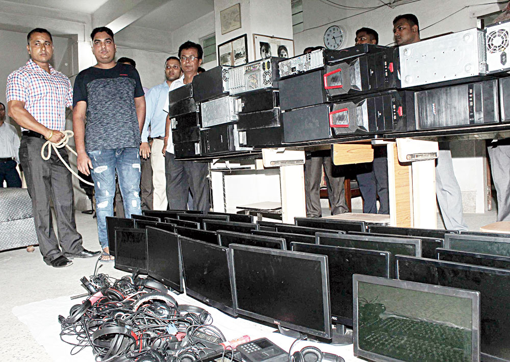 The accused and the items seized from the call centre at the CID office in Guwahati on Tuesday. 