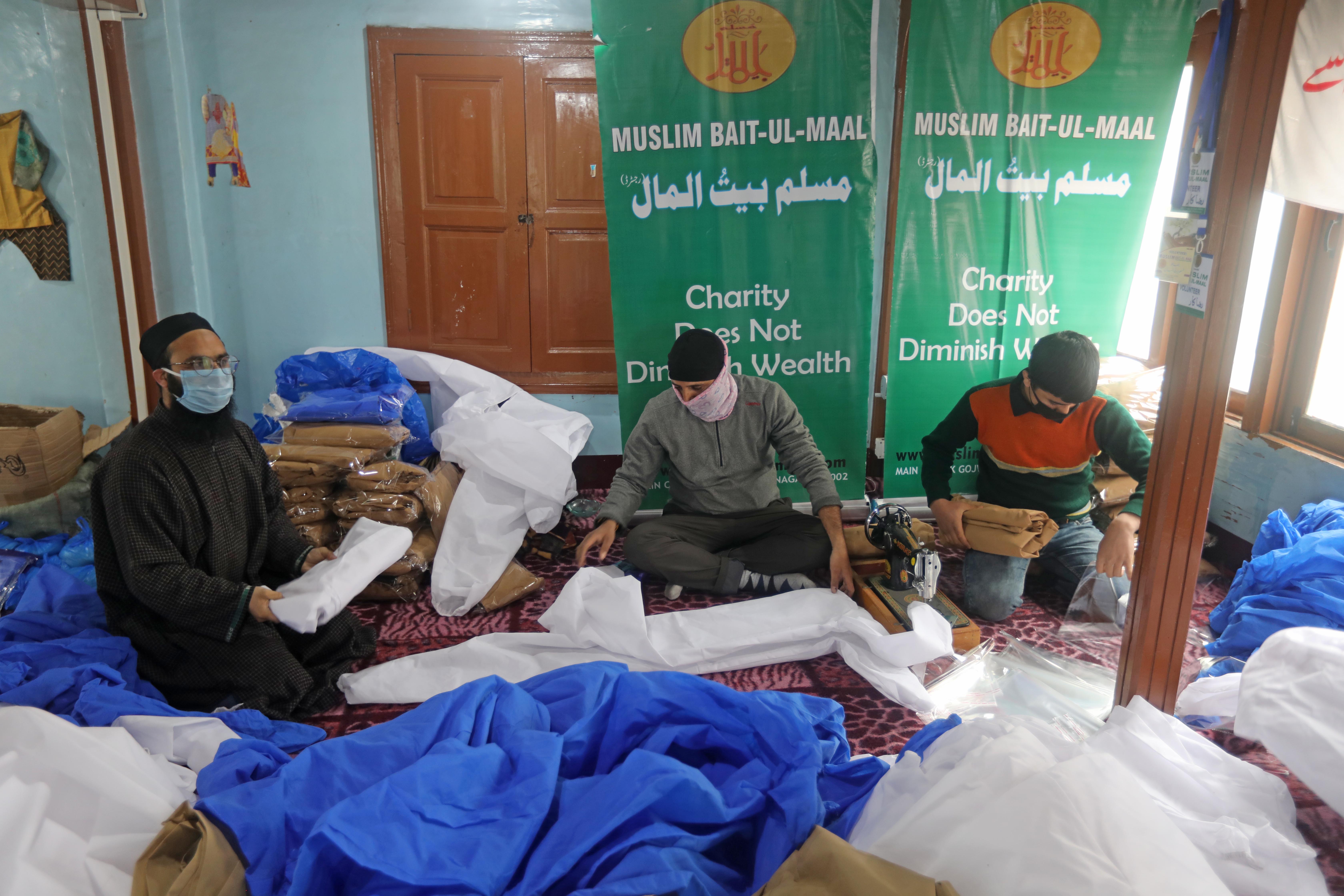HELPING OUT: In Nowhatta old city, a group of volunteers makes masks and protective suits that are to be distributed among health workers.