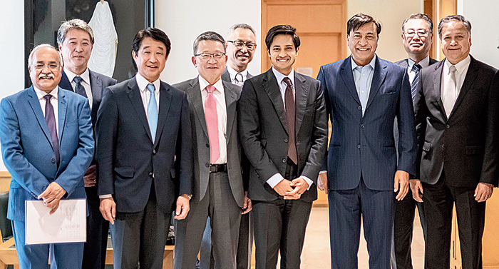 Lakshmi Mittal and Aditya Mittal with members of ArcelorMittal and Nippon Steel after completing the acquisition of Essar Steel