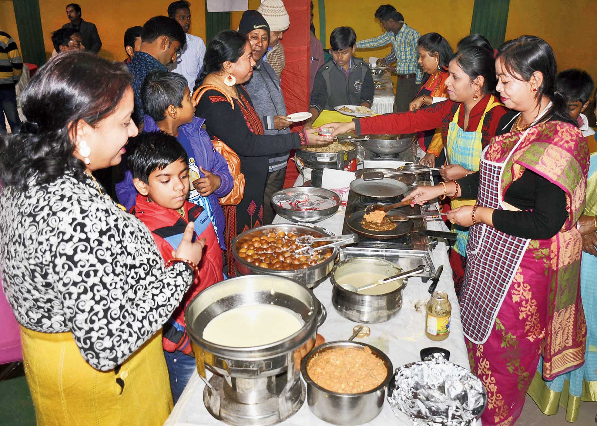 Women serve pithes to visitors at Lindsay Club in Dhanbad on Sunday. 