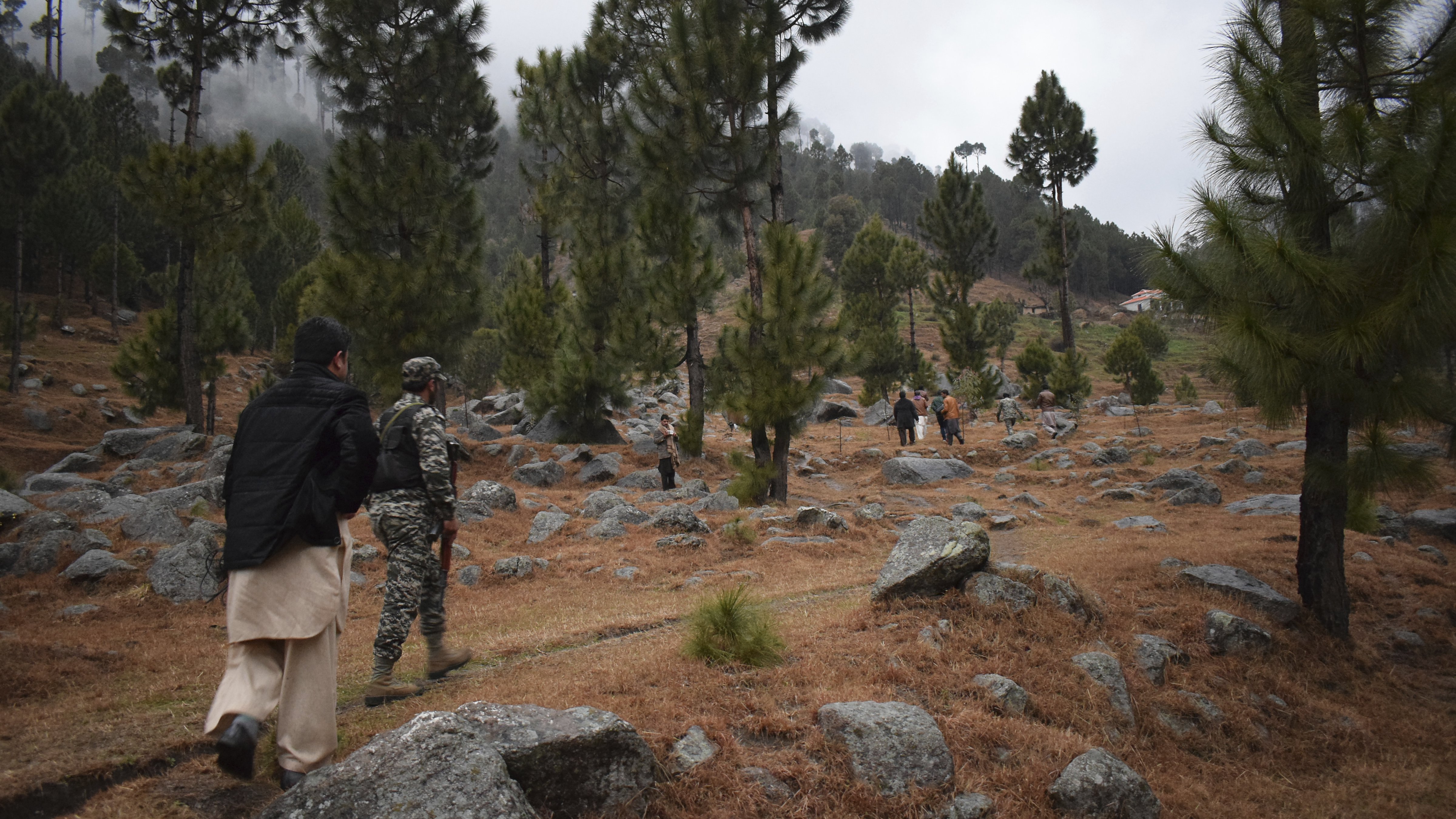 Pakistani reporters and troops visit the site of an Indian airstrike in Jaba, near Balakot, Pakistan, on Tuesday, February 26, 2019. 
