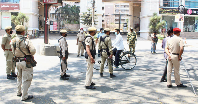 Security personnel keep vigil outside the apartment complex in Guwahati on Saturday. 
