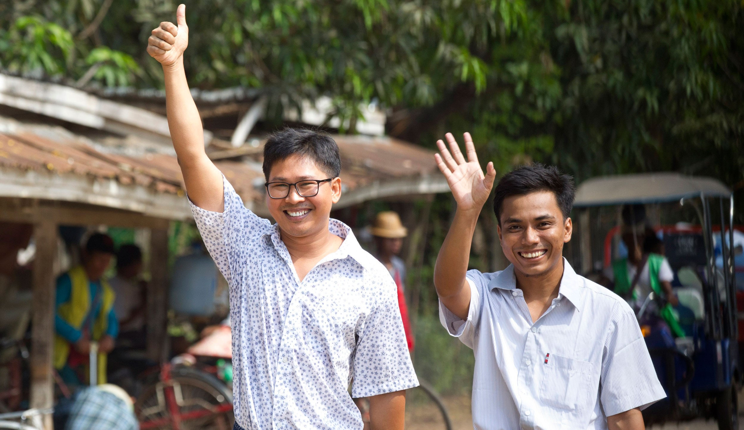 Reuters journalists Wa Lone (left) and Kyaw She Oo wave as they walk out from Insein Prison in Yangon, Myanmar on May 7, 2019. 