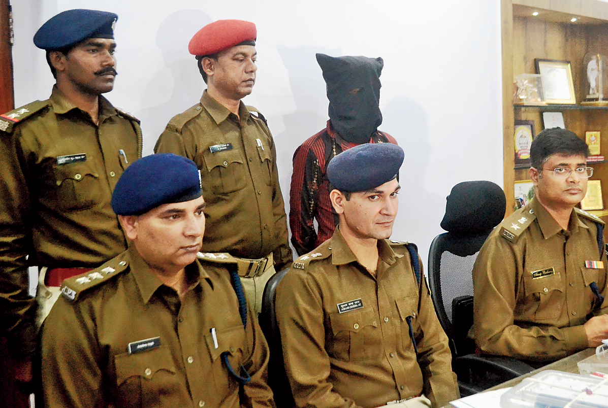 SSP Anoop Birtharay (extreme right) with the accused (masked) in Jamshedpur on Sunday. 