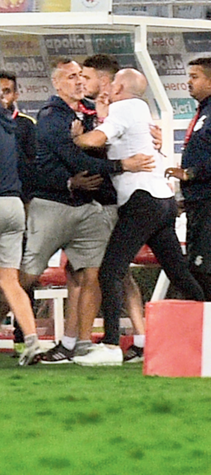 Antonio Lopez Habas being restrained by a member of ATK support staff on Sunday. 