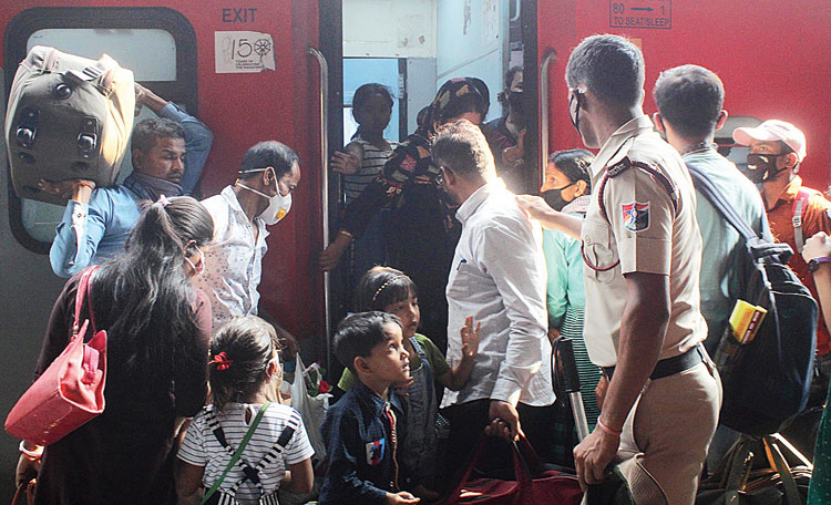 Migrant workers and their families at Guwahati railway station. 