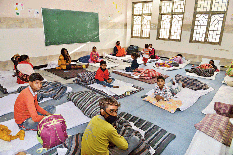 Migrant workers given shelter inside a Delhi government school at Ghazipur in east Delhi during the lockdown on Monday
