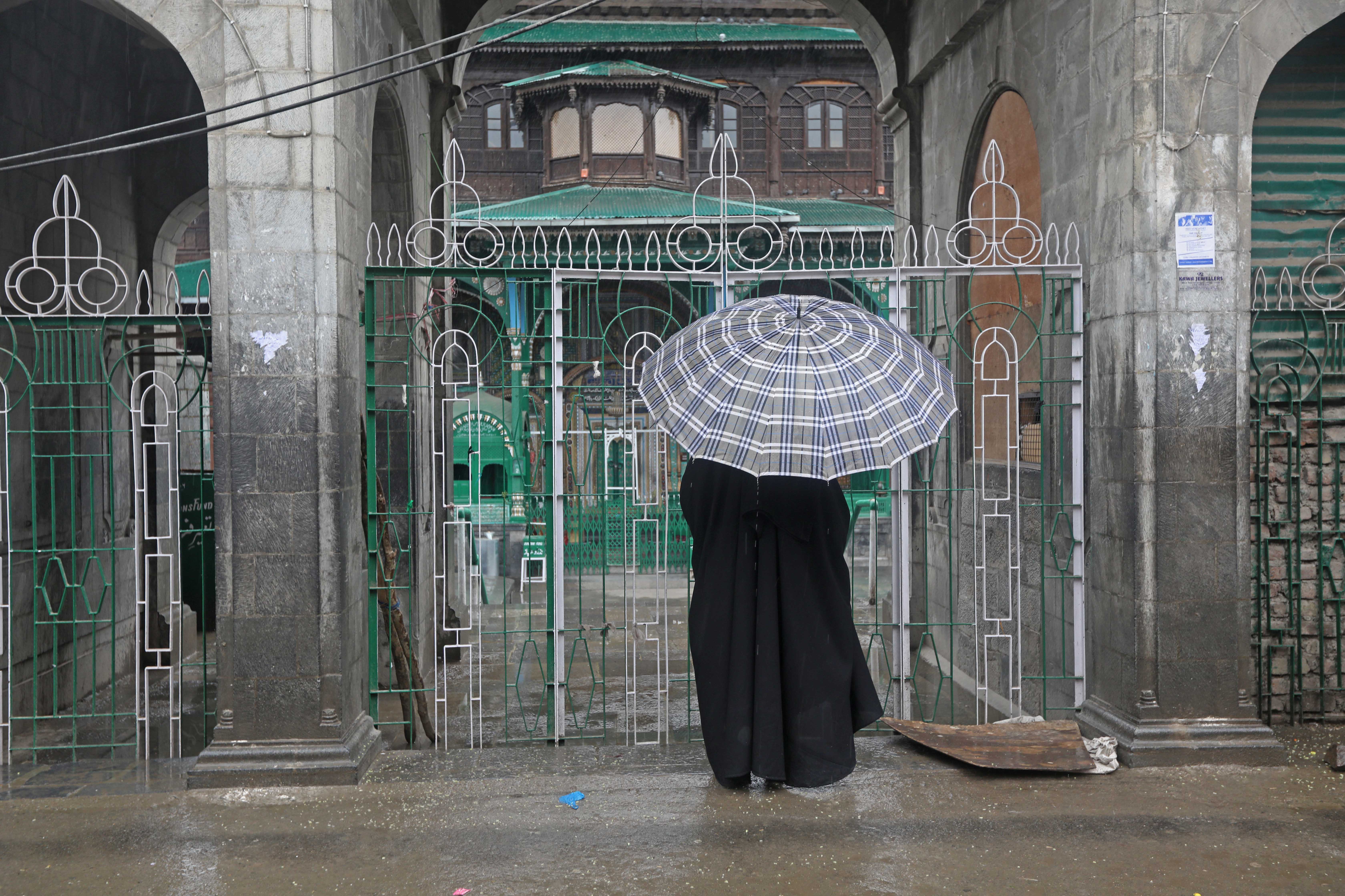 IN PRAYER: A woman stands outside a locked shrine (Khanqah-e-Moula) in the old city, Srinagar.
