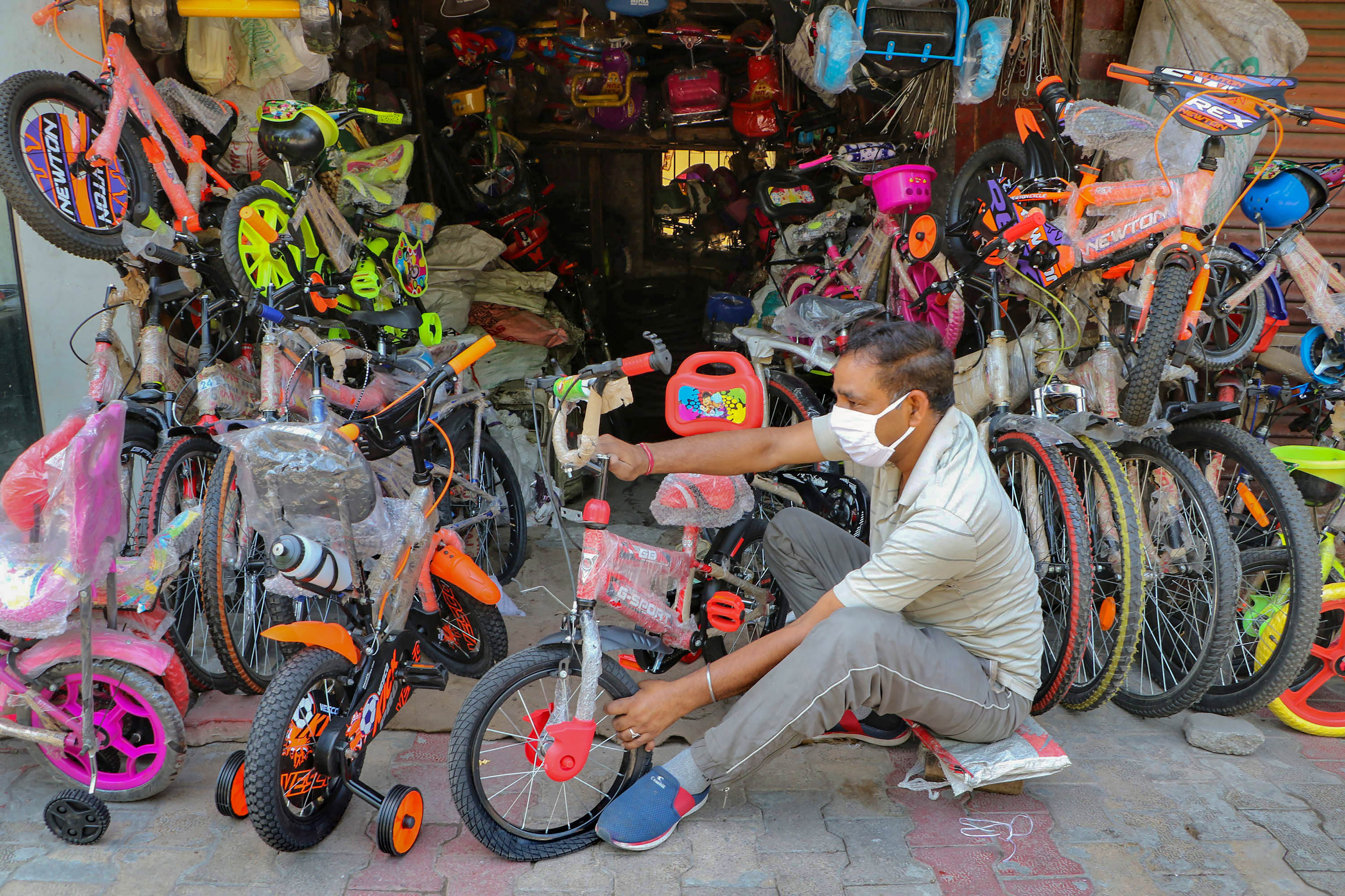 A shopkeeper displays cycles outside his shop after the authorities allowed them to open their establishments, during the ongoing Covid-19 lockdown, in Jammu, Wednesday, May 20, 2020