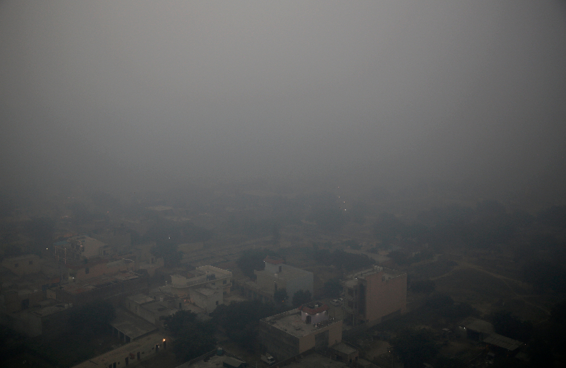 A haze envelops the skyline on the outskirts of New Delhi on the morning of Thursday, November 8, after tens of thousands of people lit firecrackers to celebrate Diwali on Wednesday night.