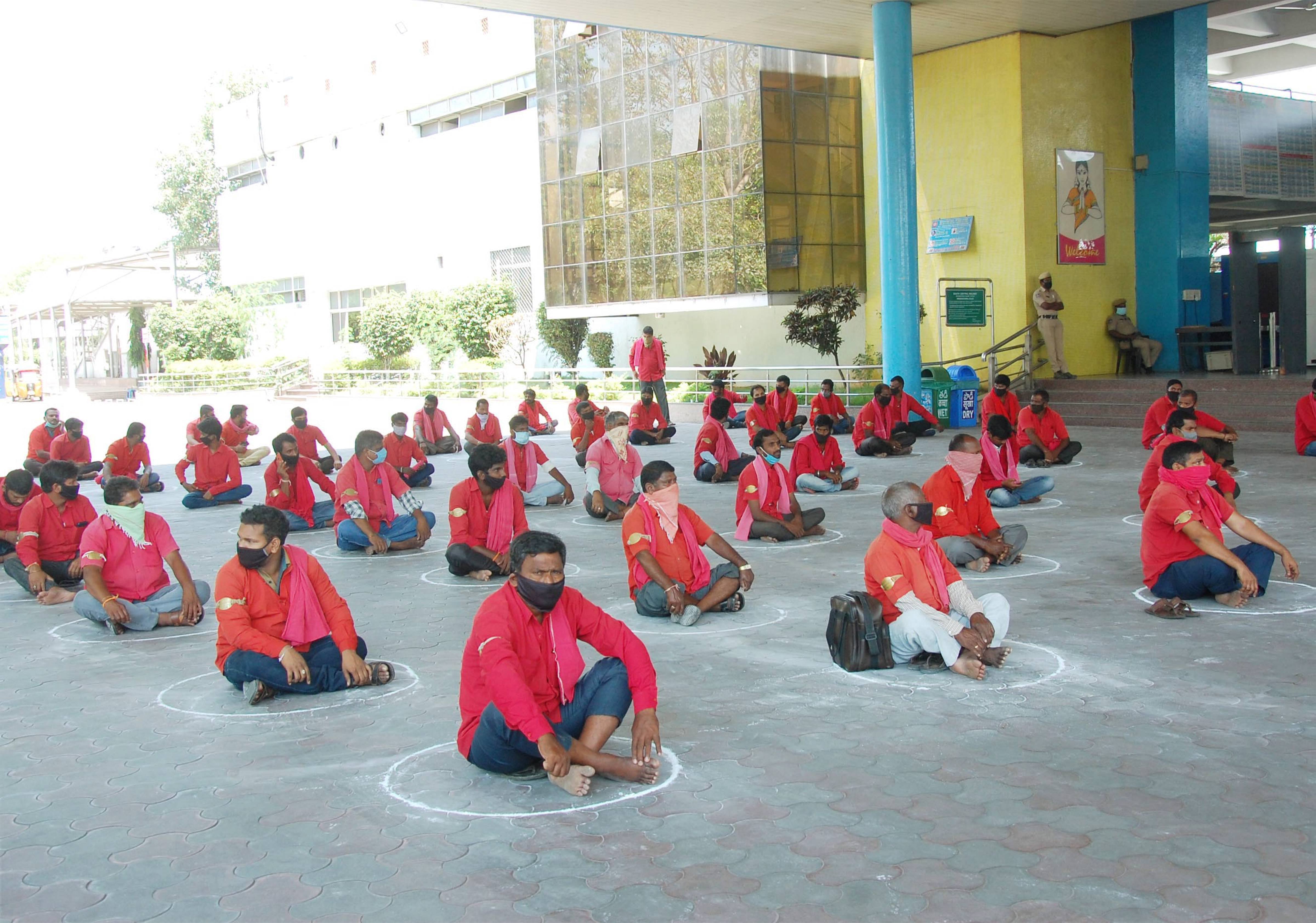 Railway workers maintain social distance as they wait to receive relief materials, during the nationwide lockdown to curb the spread of coronavirus, at Secunderabad in Hyderabad, Wednesday, April 29, 2020.