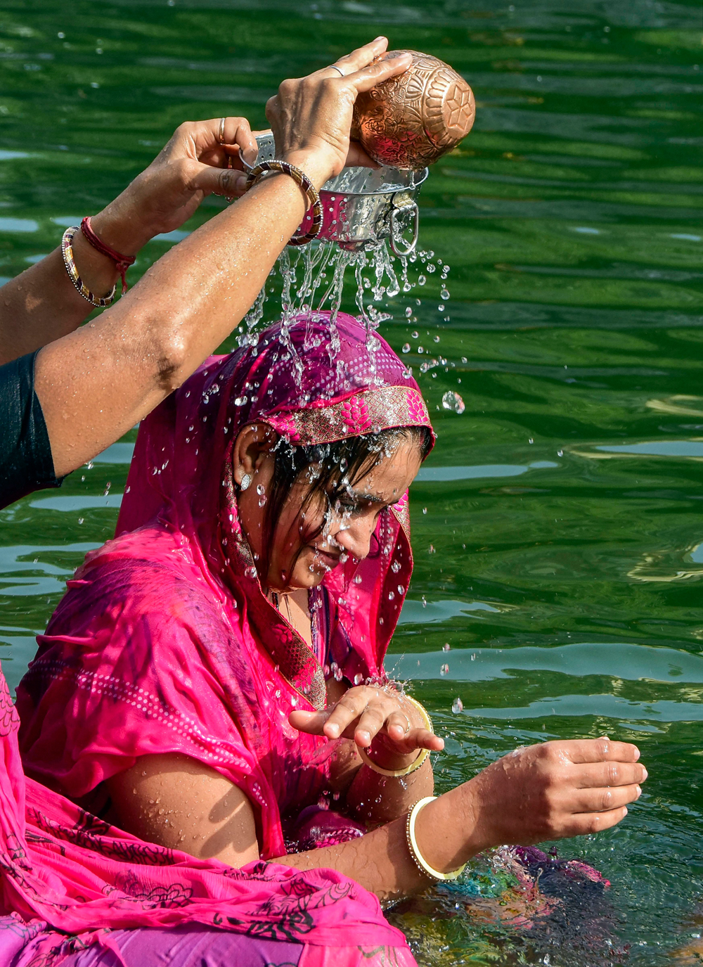 Devotees perform rituals during the solar eclipse in Mumbai on December 26