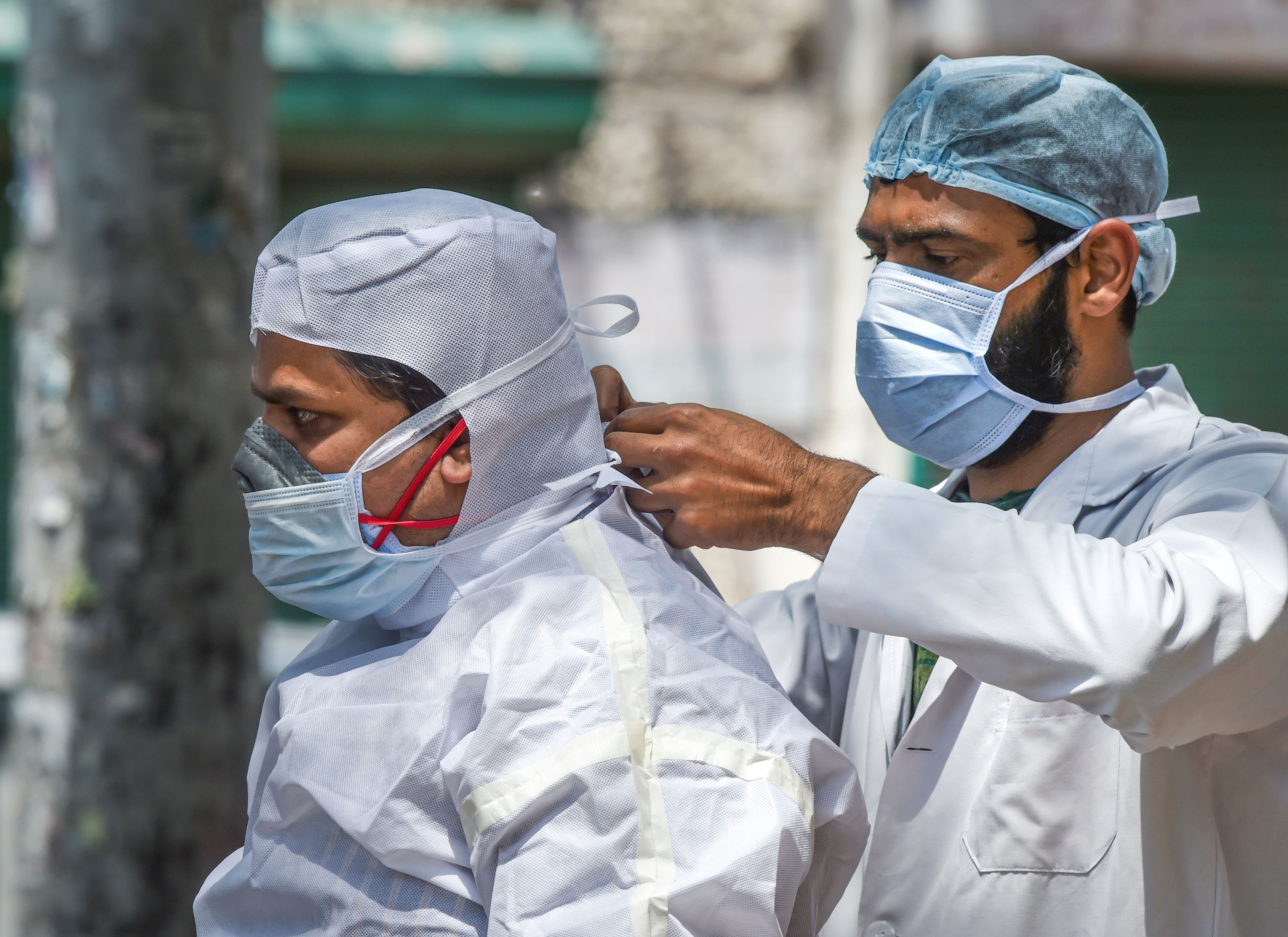 Medics prepare before collecting samples for swab tests from a Covid-19 mobile testing van, during the nationwide lockdown to curb the spread of coronavirus, at Ramakrishna Mission area in New Delhi, Saturday, May 2, 2020