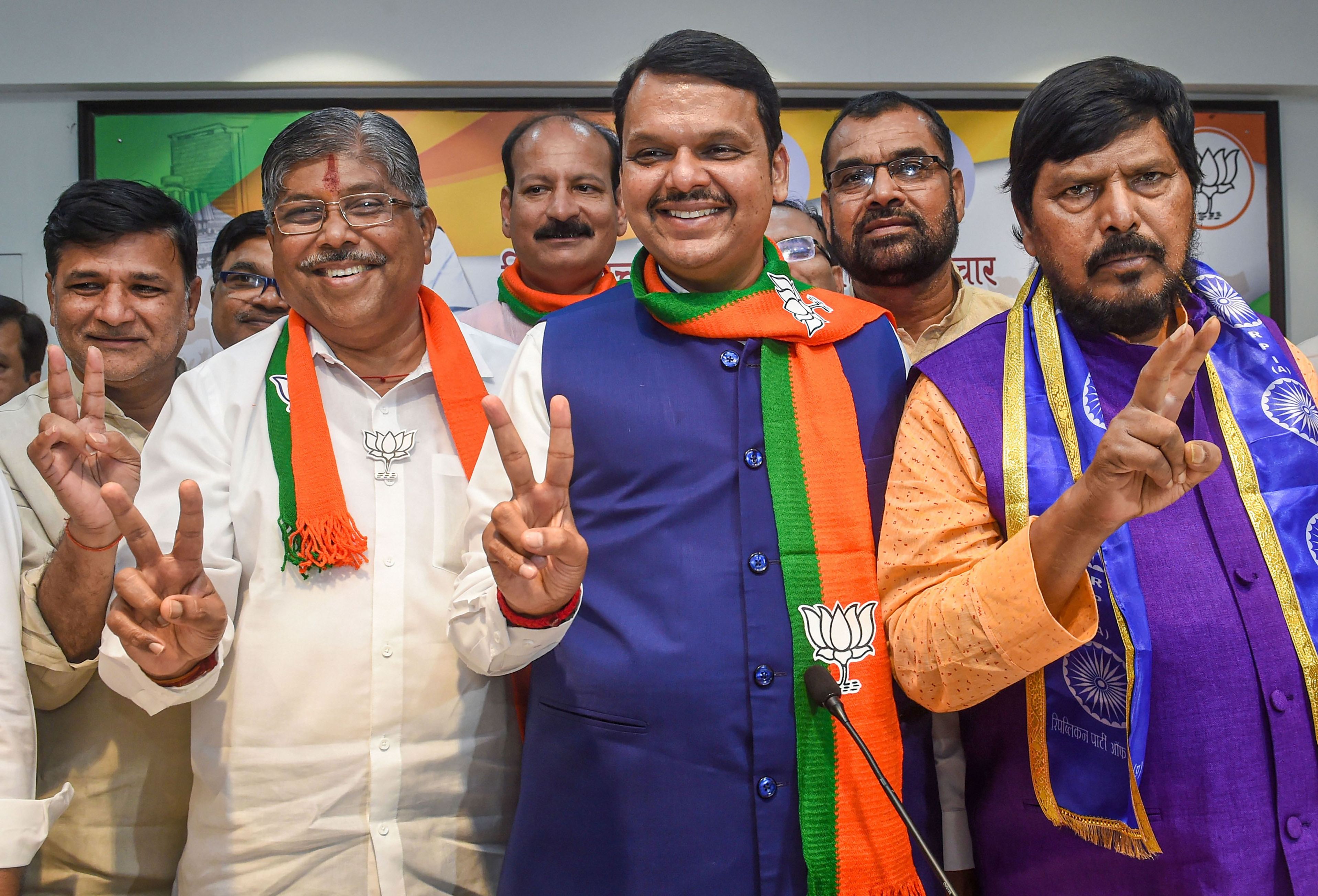 (From left to right) Maharashtra BJP president Chandrakant Patil, stat chief minister Devendra Fadnavis and RPI chief Ramdas Athawale flash victory signs as they celebrate their win in Maharashtra Assembly elections, in Mumbai, Thursday, October 24, 2019.