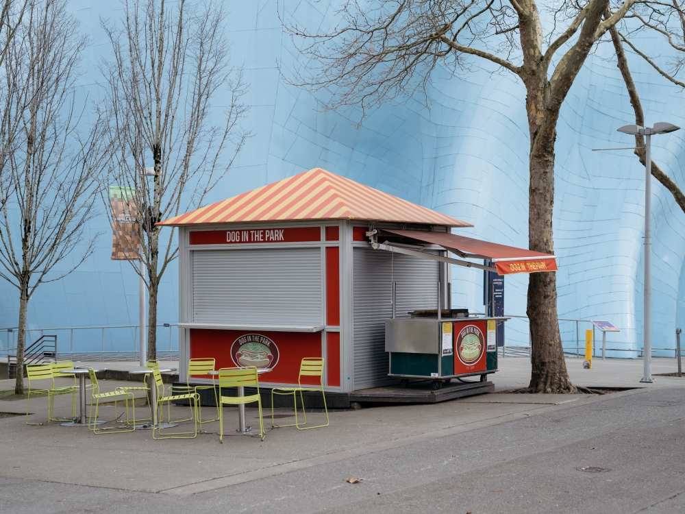 A closed hotdog stand nestled under a closed Space Needle and Museum of Pop Culture in Seattle, March 14, 2020