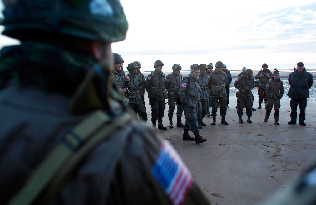 World War II re-enactors from Switzerland gather at dawn on Omaha Beach, in Normandy, France, Thursday, June 6, 2019 during commemorations of the 75th anniversary of D-Day.