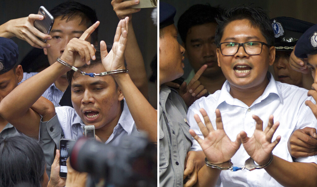 Reuters journalists Kyaw Soe Oo (left) and Wa Lone are escorted by police out of the court in Yangon on September 3, 2018.