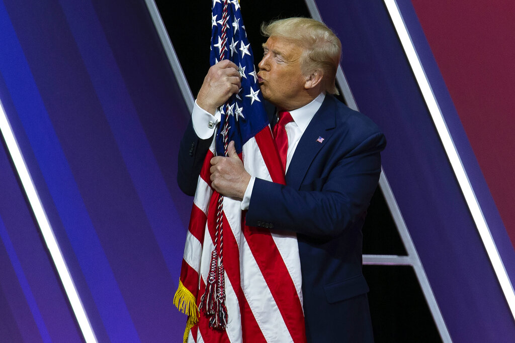 President Donald Trump kisses the American flag after speaking at Conservative Political Action Conference, CPAC 2020, at the National Harbor in Oxon Hill, Maryland, USA on Saturday
