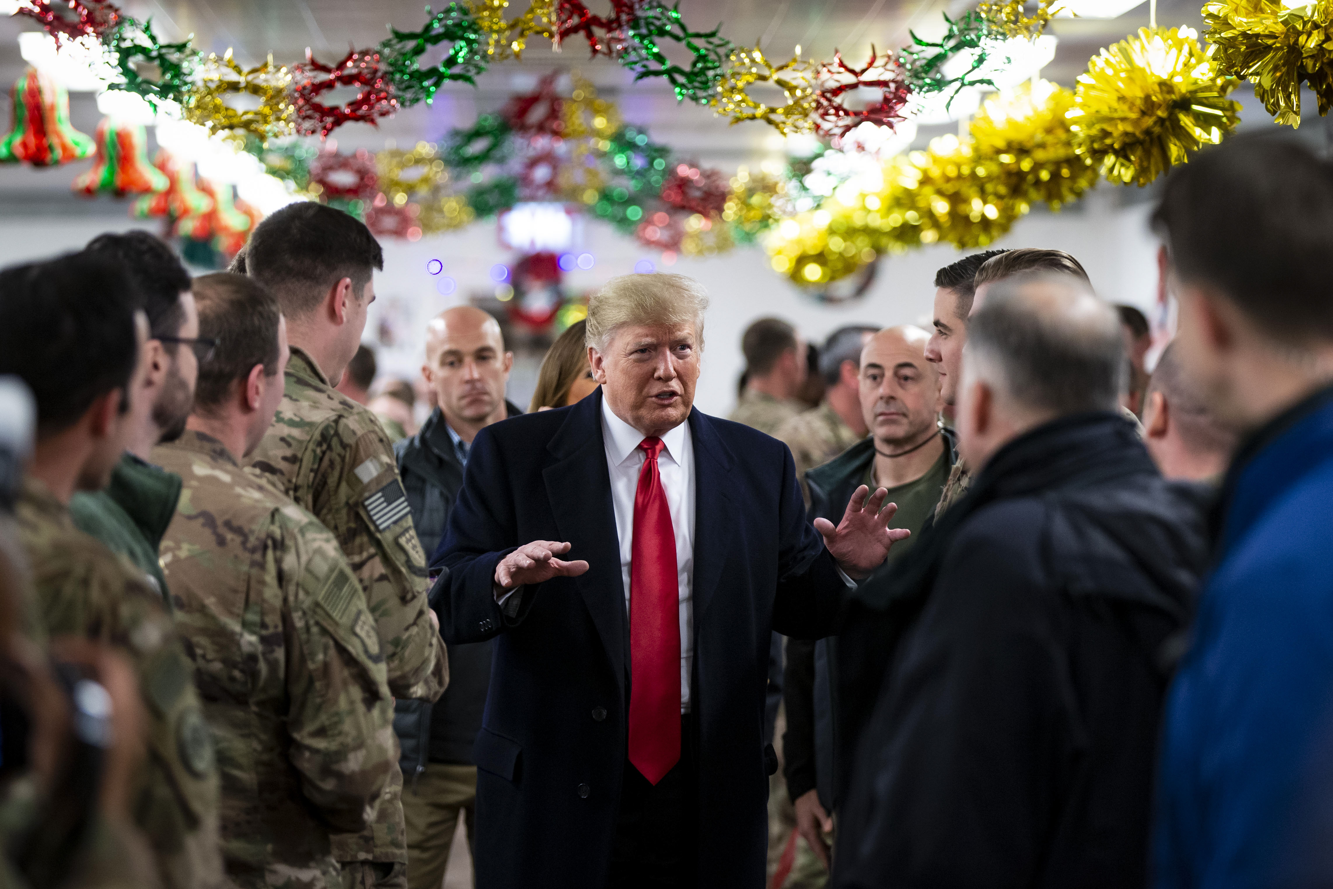 Donald Trump visits members of the US military at a dining hall at the Al Asad Air Base in Iraq on December 26, 2018. 