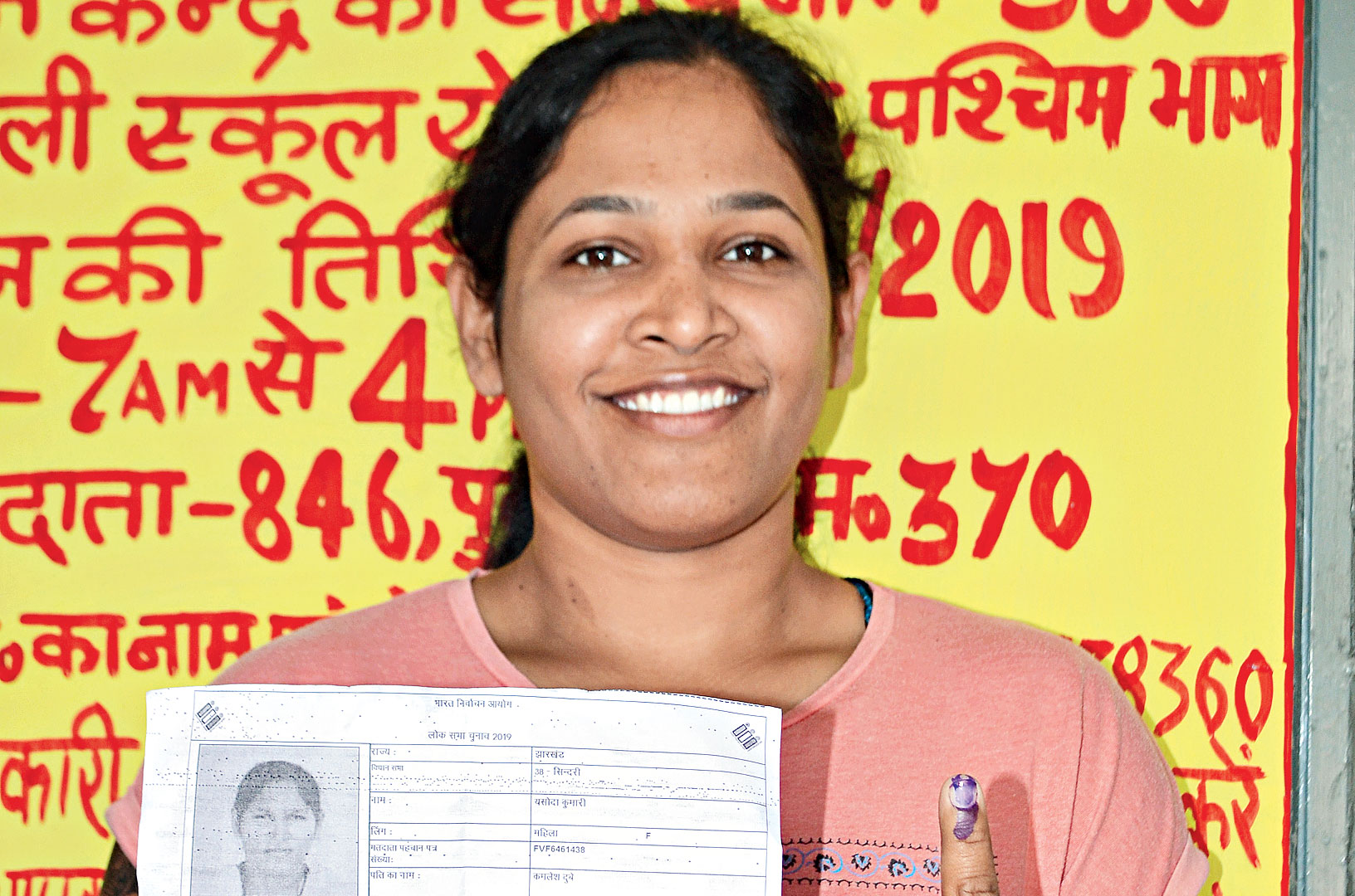 Yashoda Kumari shows her inked finger in Sindri, Dhanbad.