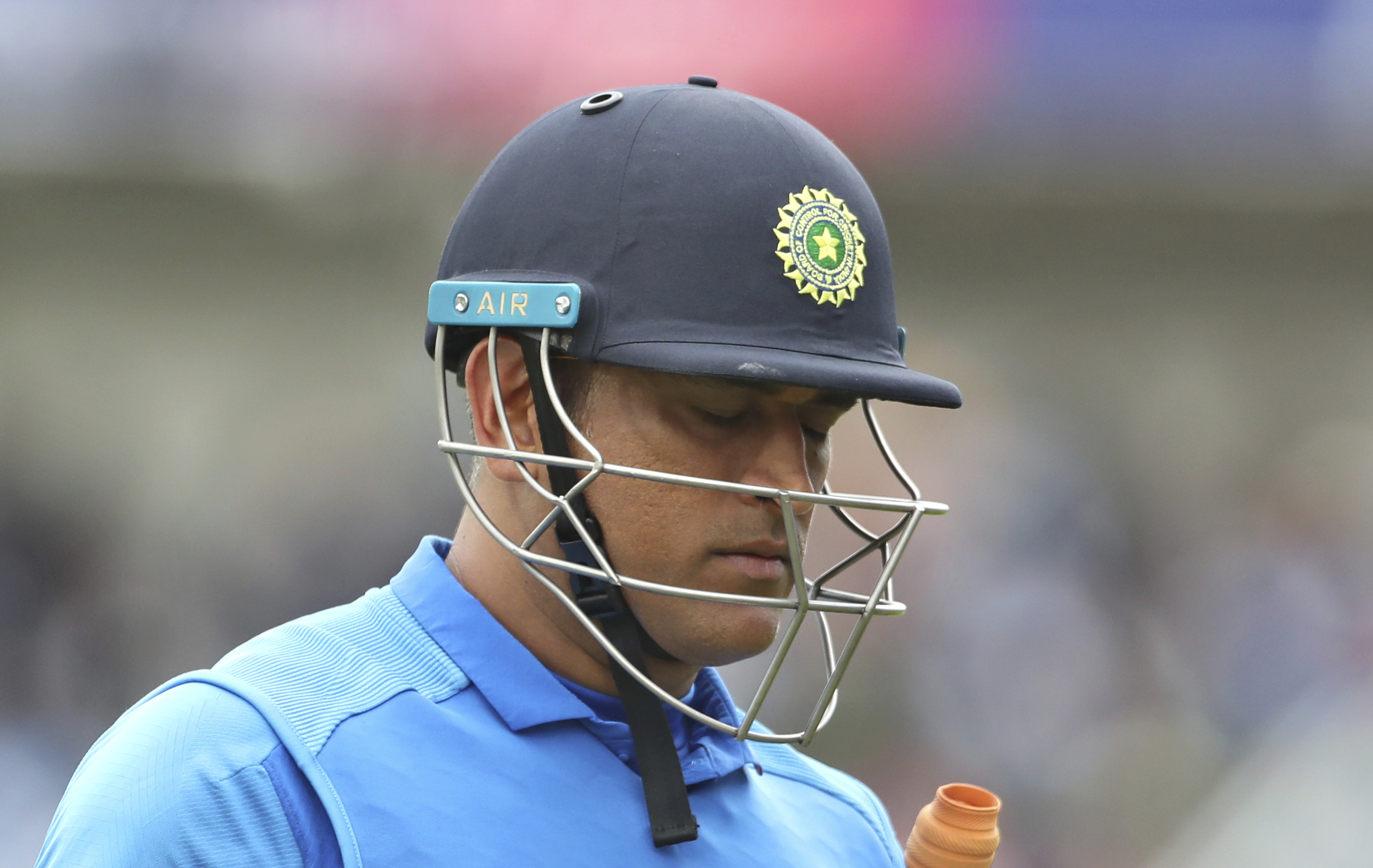 Dhoni leaves the field after being dismissed by Martin Guptill in the semi-final between India and New Zealand at Old Trafford on July 10.