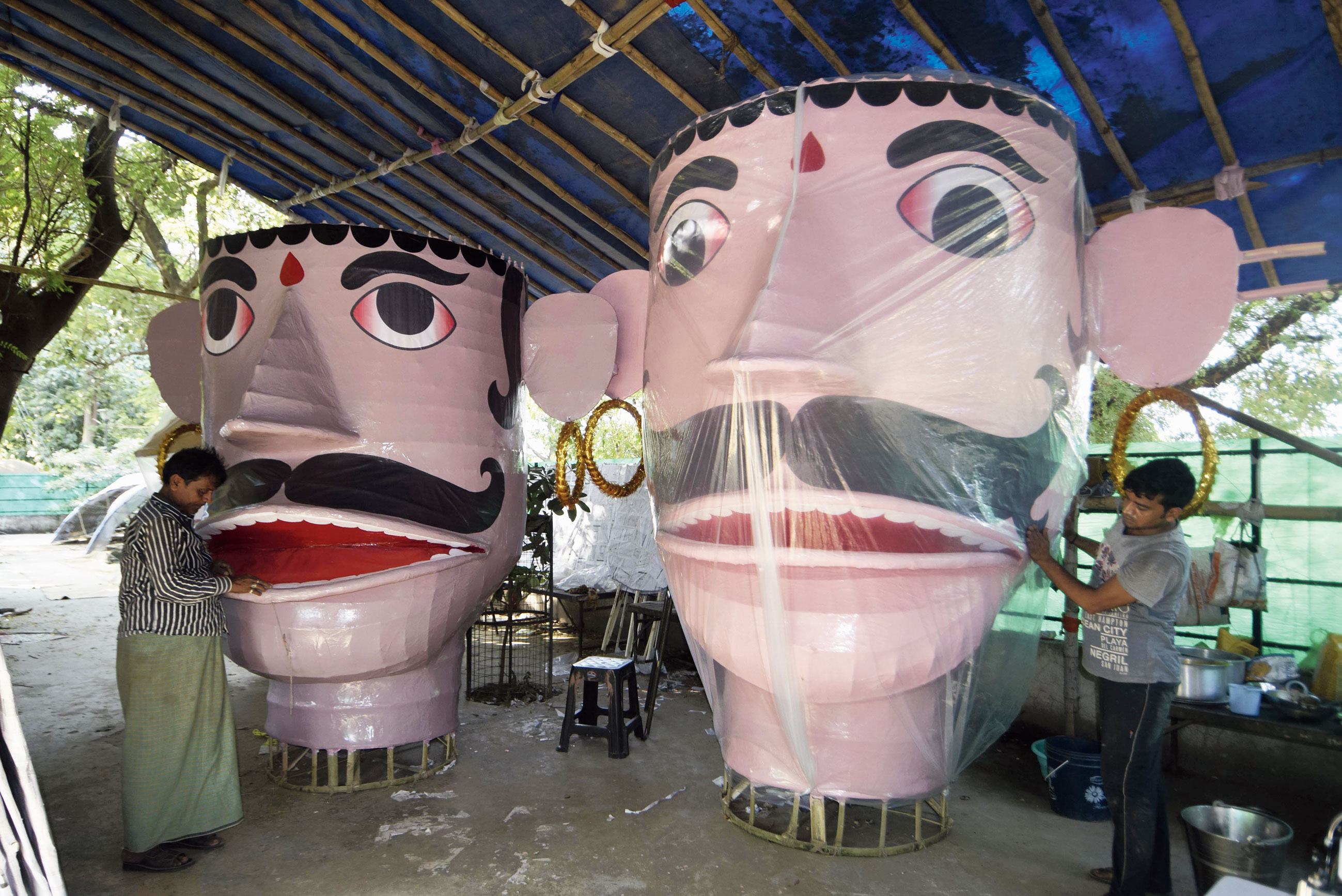 An artist works on idols ahead of Dussehra at Gandhi Maidan.