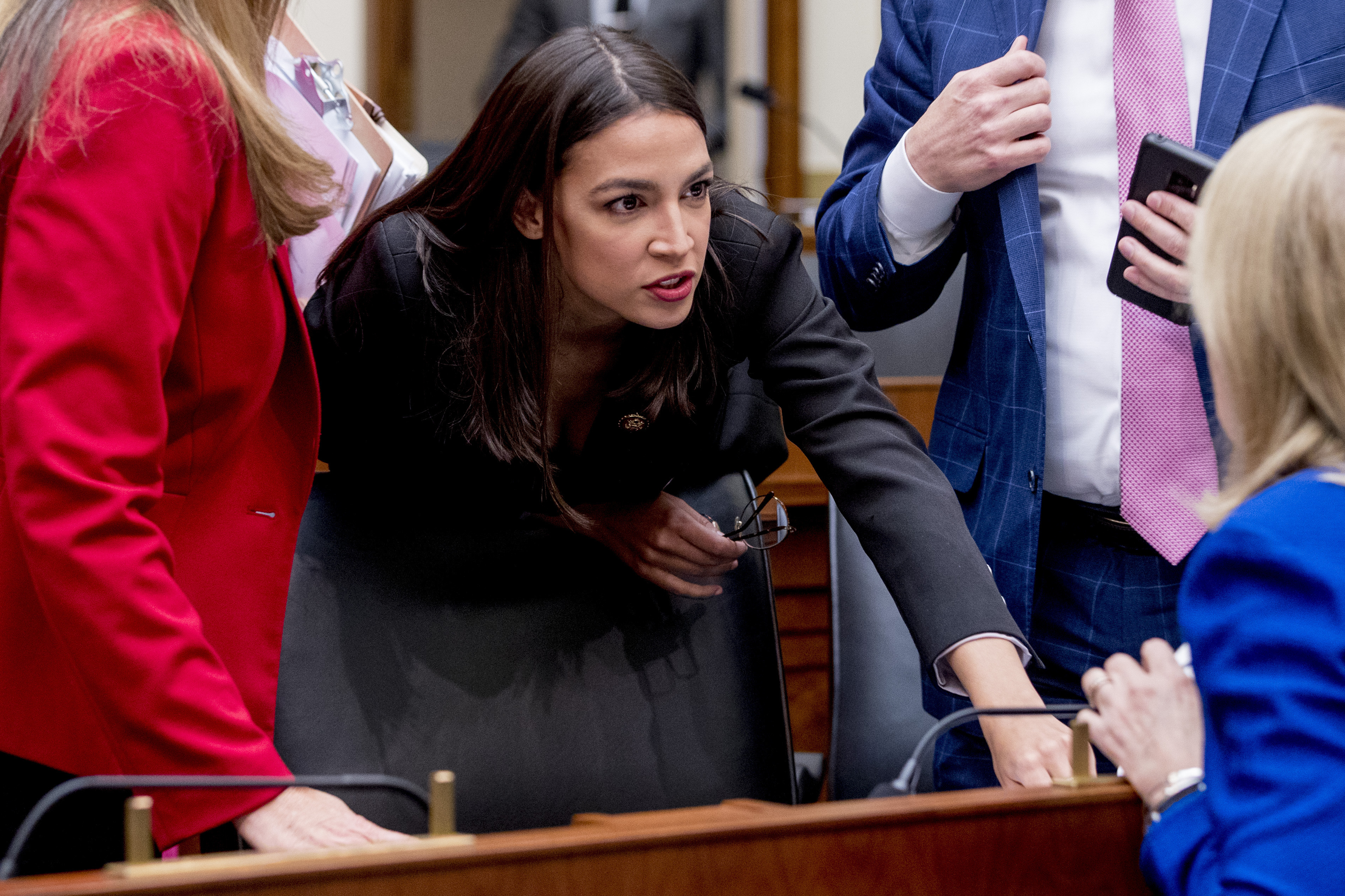 Alexandria Ocasio-Cortez speaks with other lawmakers during a break from testimony from Mark Zuckerberg before a House Financial Services Committee hearing on Capitol Hill in Washington, on Wednesday.