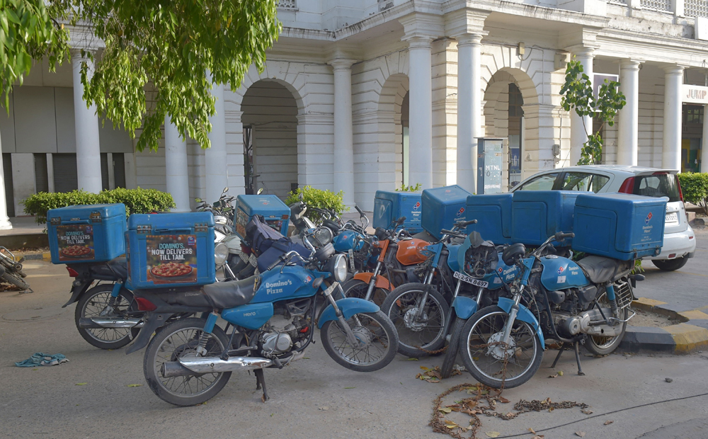 Bikes of delivery men parked near a building at Connaught Place during the nationwide Covid-19 lockdown, in New Delhi, Thursday, April 16, 2020. 