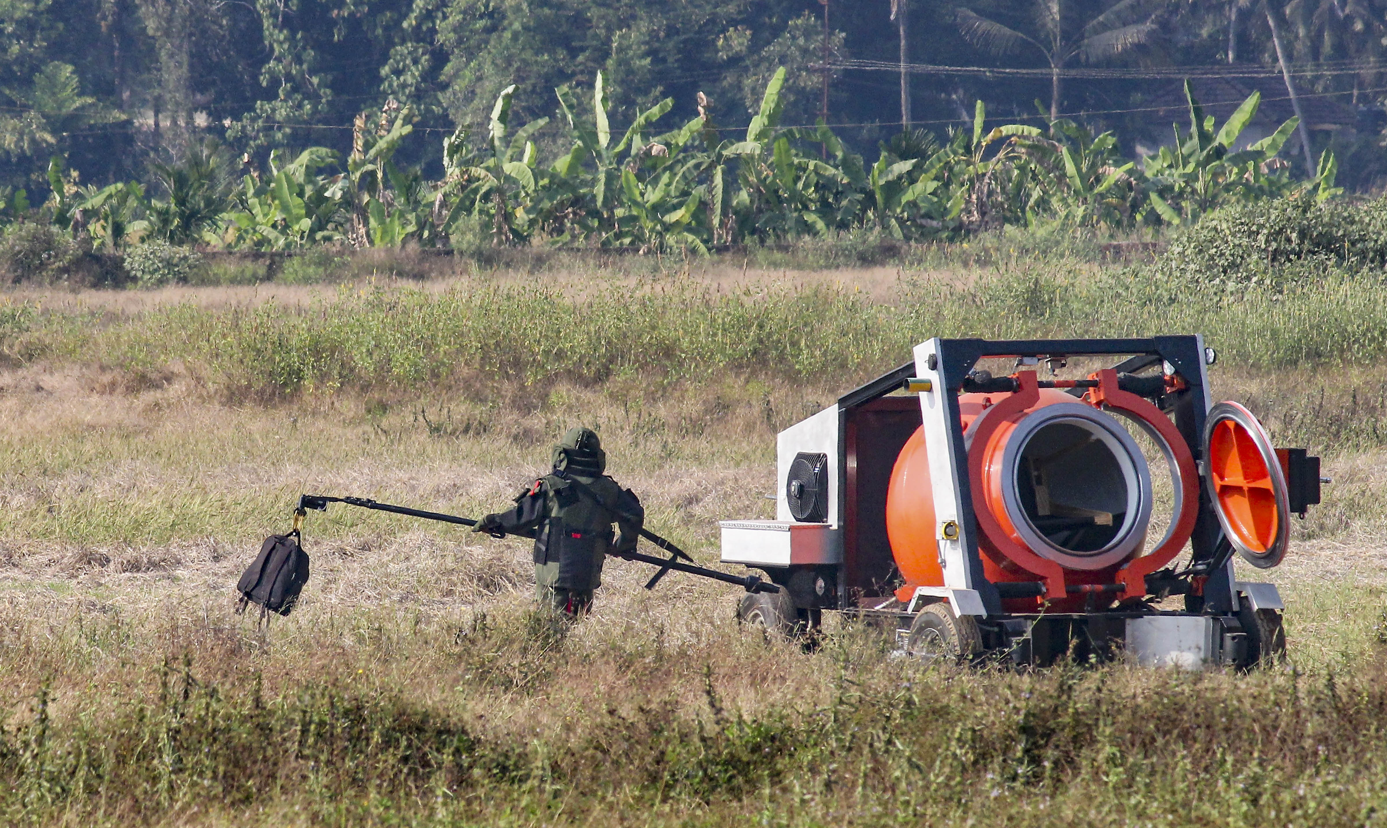 A bomb disposal squad member carries a bag, containing an IED component, for defusal, after it was found at the airport in Mangaluru, Monday, January 20, 2020.