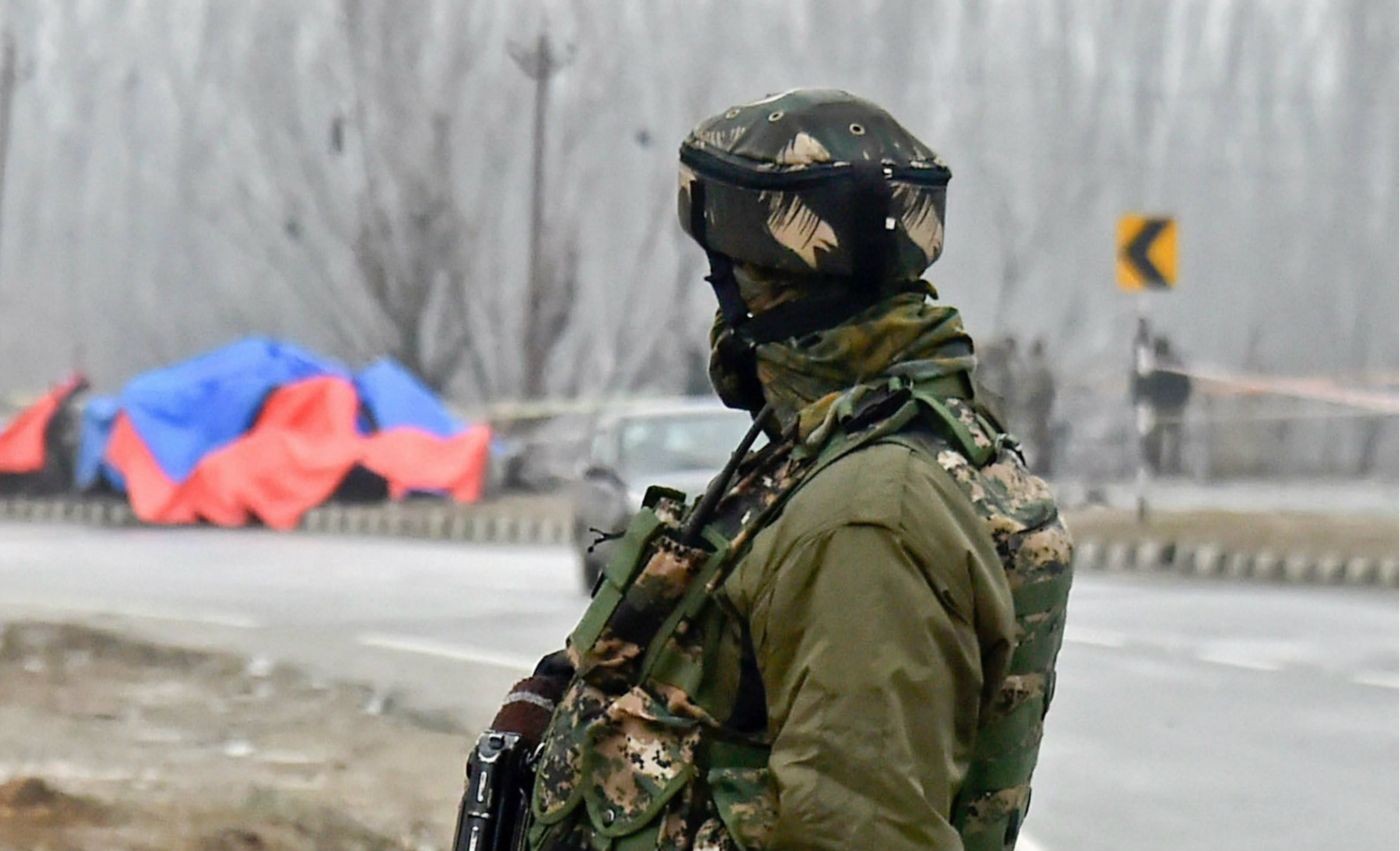 A jawan stands guard at the site of the suicide bomb attack in Pulwama district on Friday.