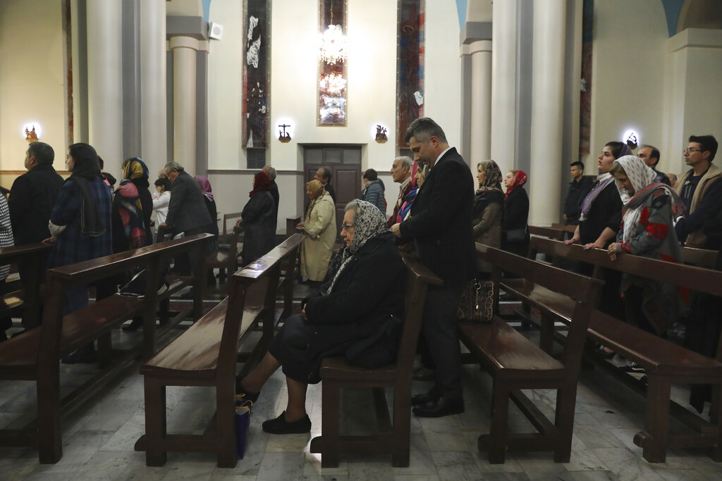 Iranian Christians celebrate Christmas Eve mass at the Saint Joseph Chaldean-Assyrian Catholic church, in Tehran, Iran, Tuesday, Dec. 24, 2019. Christianity is a recognized religion by the country's constitution; Christians have representatives at the parliament, can go to their own schools and vote in the elections.