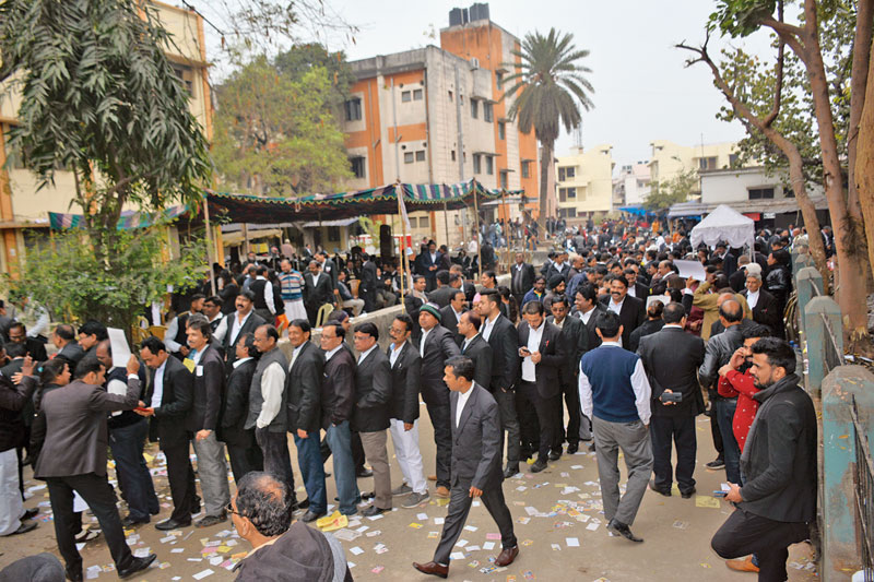 Advocates stand in queue during the polling of the new executive body of Jamshedpur Bar Association   at Humepipe on Friday.  