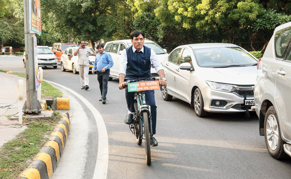 Mansukh Mandaviya, a BJP MP from Gujarat, rides a bicycle to the Rashtrapati Bhavan to attend the swearing-in ceremony of Narendra Modi
