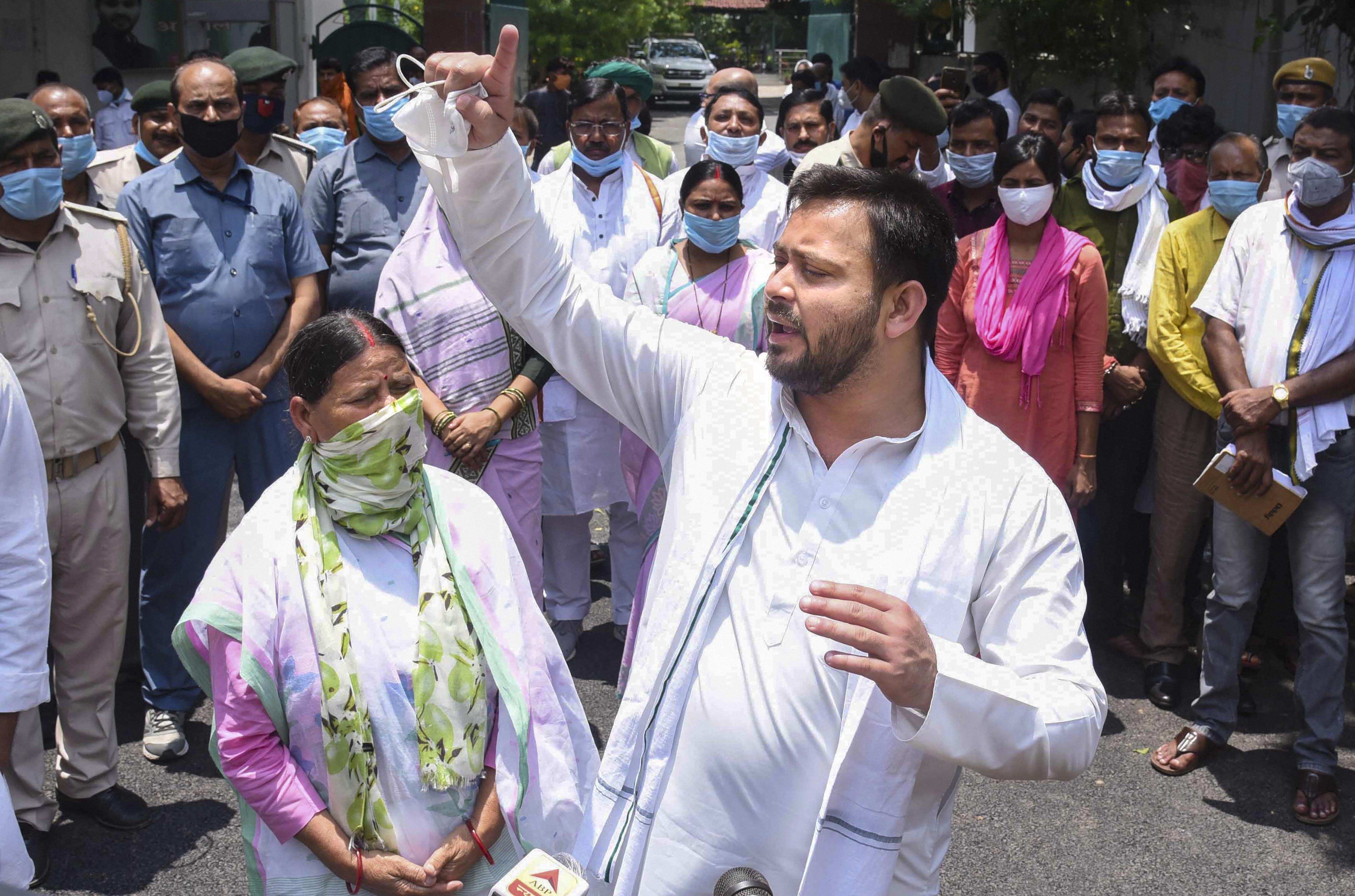 RJD leader Tejashwi Yadav along with his mother and senior leader Rabri Devi talks to the media after a protest against the Bihar government over migrants issues, in Patna, Sunday, June 7, 2020.