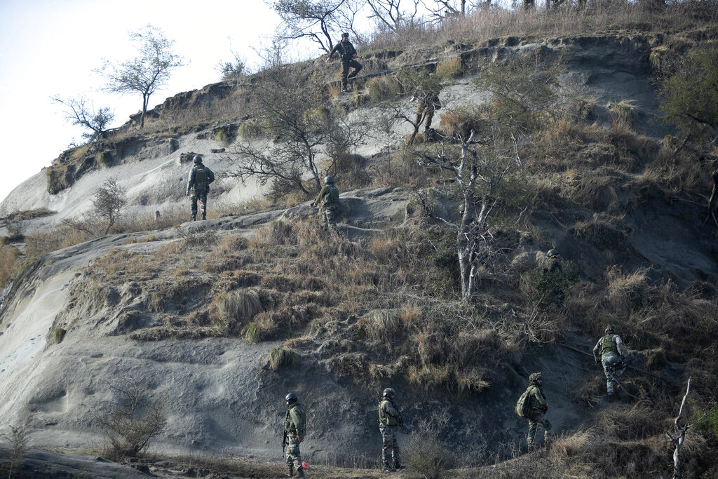 Indian security force soldiers patrol near the site of a gun-battle at Nagrota , on the outskirts of Jammu, on Friday