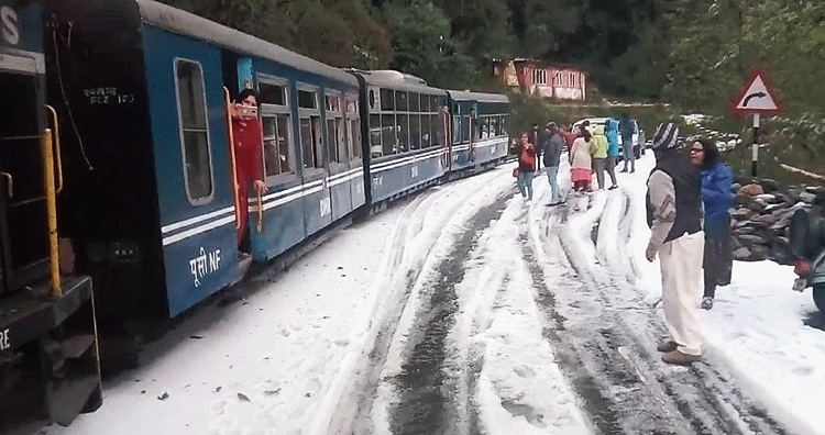 A toy train passes through the hailstorm-hit Tindharia.