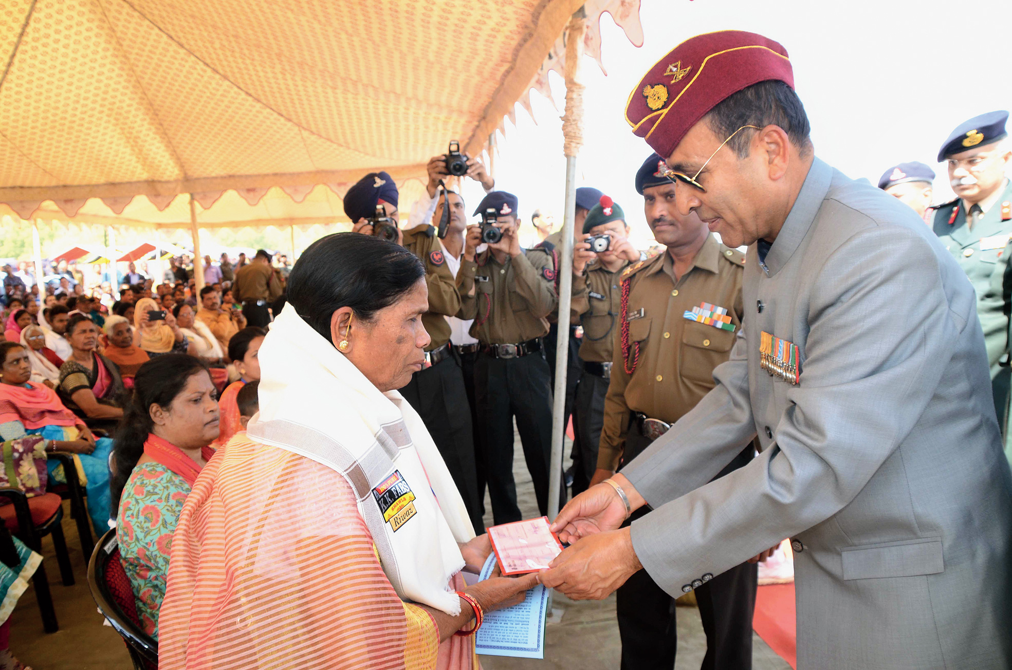 Retired Lieutenant-general Gyan Bhushan honours a widow at the programme.